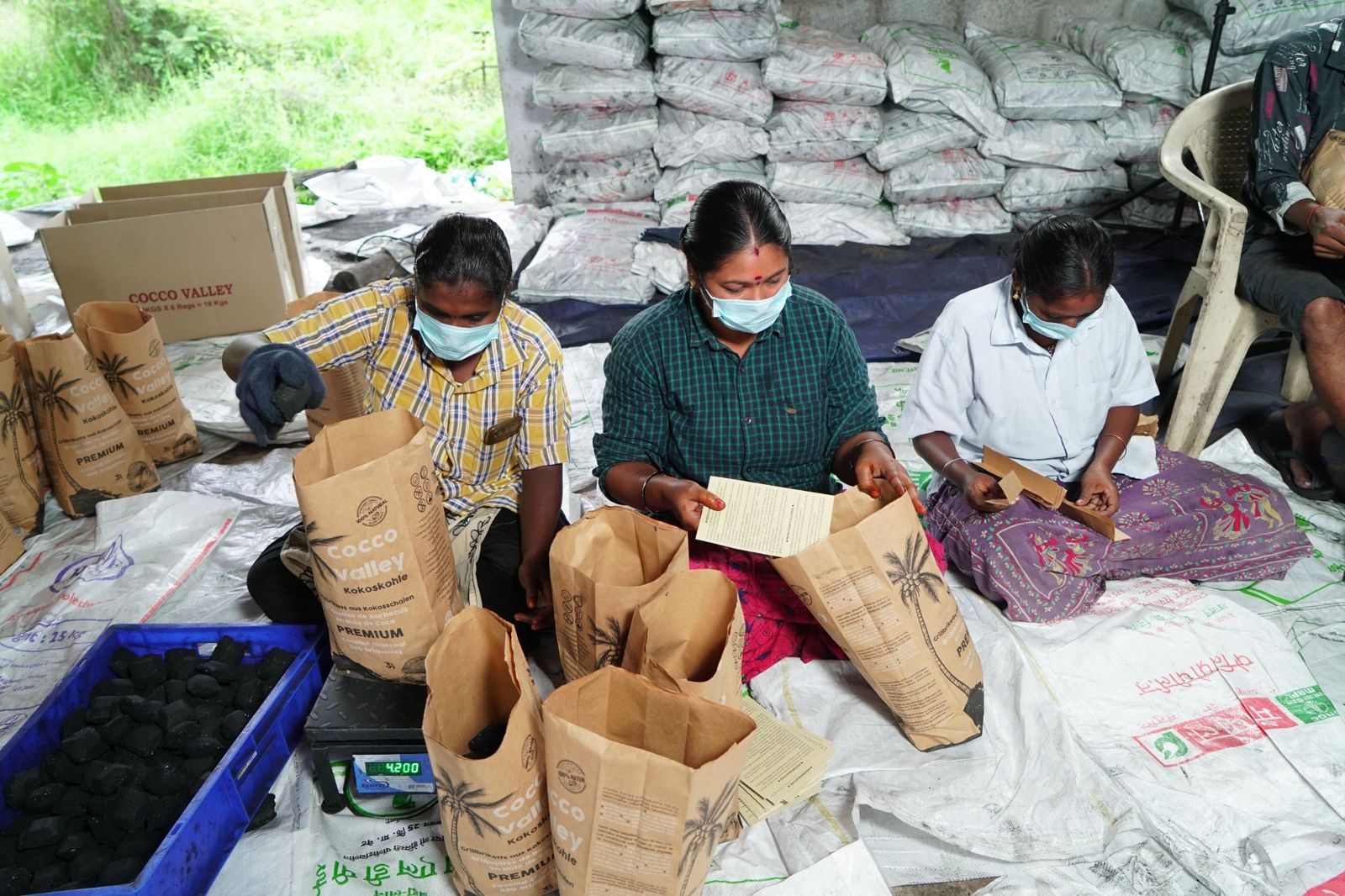Women packing Cocco Valley coconut briquettes