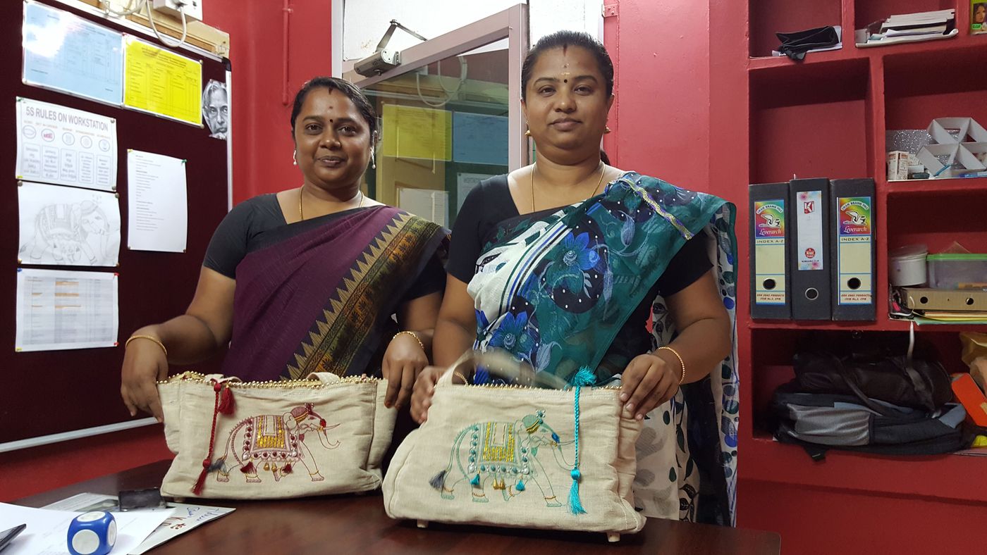Women standing with their jute bags